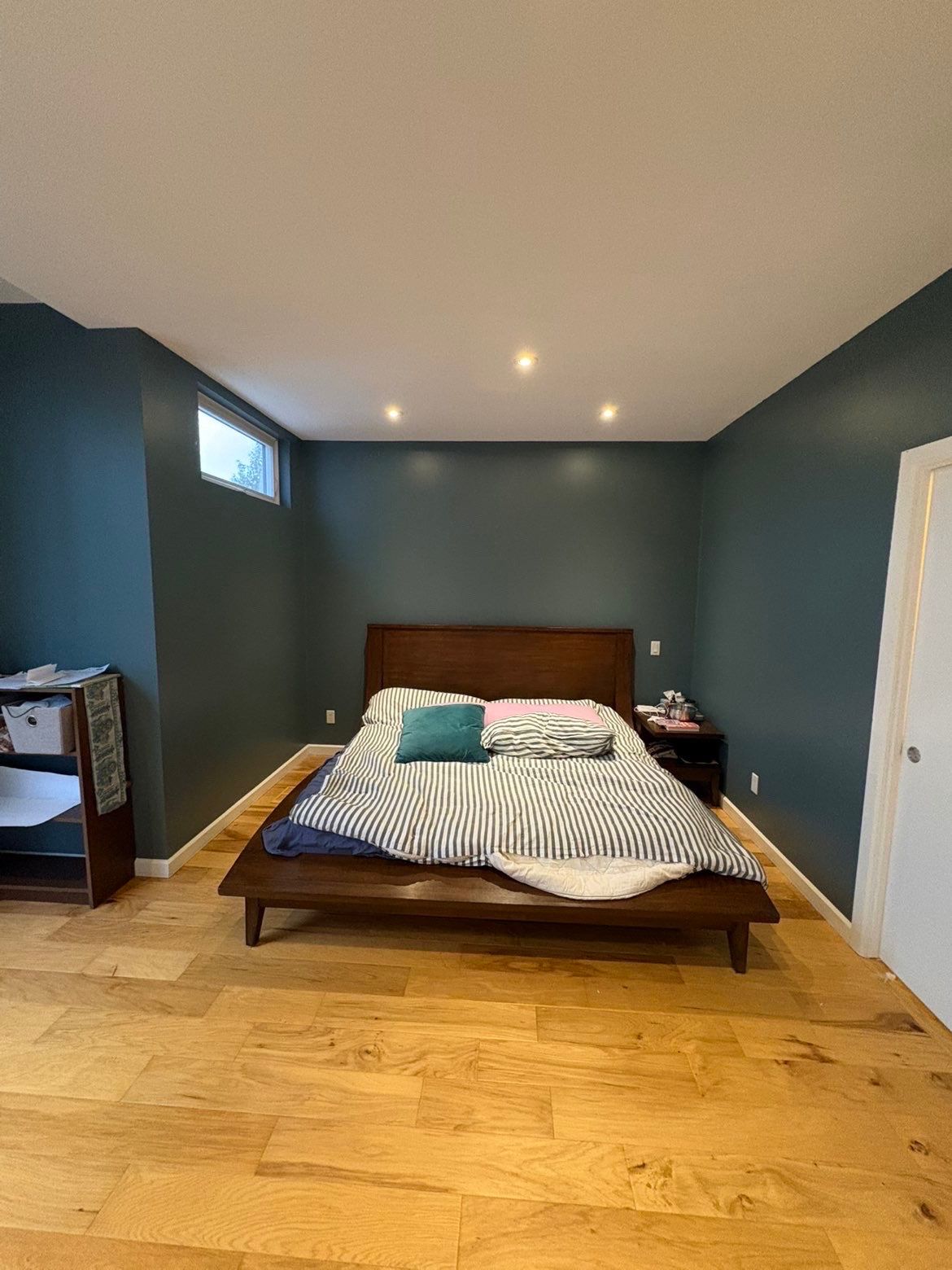 Freshly painted bedroom with deep teal walls
